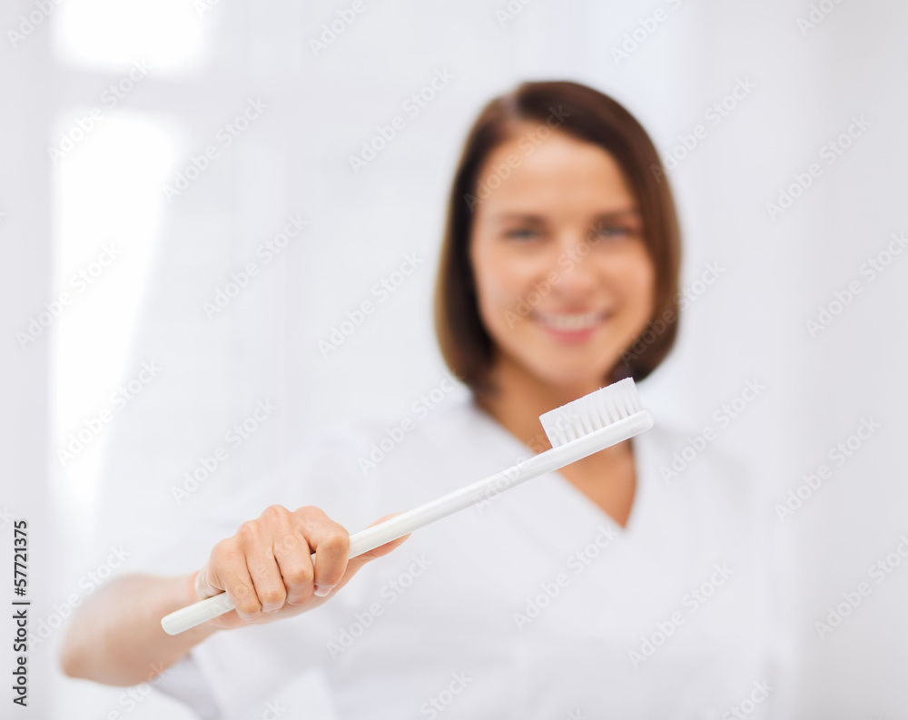 dentist with toothbrush in hospital