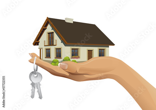 Miniature house building on hand with keys