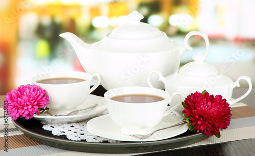 Cups of tea on tray on table in cafe