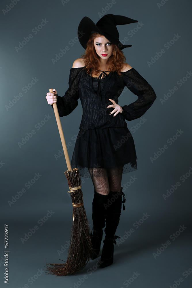 Halloween witch with broom on gray background Stock Photo | Adobe Stock