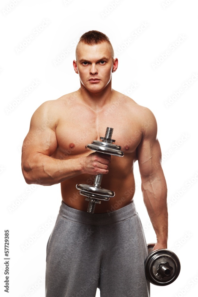 Handsome young muscular man exercising with dumbbells Handsome young muscular man exercising with dumbbells