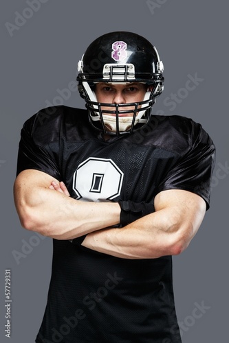 American football player wearing helmet and black jersey