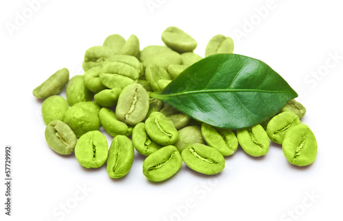 Green coffee beans with leaf on white background.