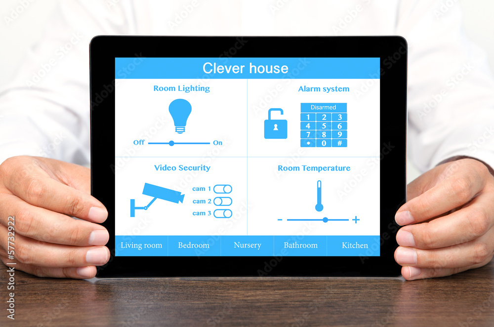 businessman holding a tablet computer with system clever house businessman holding a tablet computer with system clever house