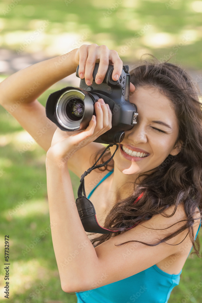 High angle view of cheerful young woman taking a picture High angle view of cheerful young woman taking a picture