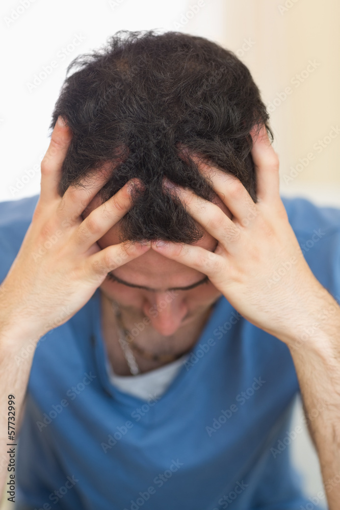 Casual worried man sitting on couch Casual worried man sitting on couch