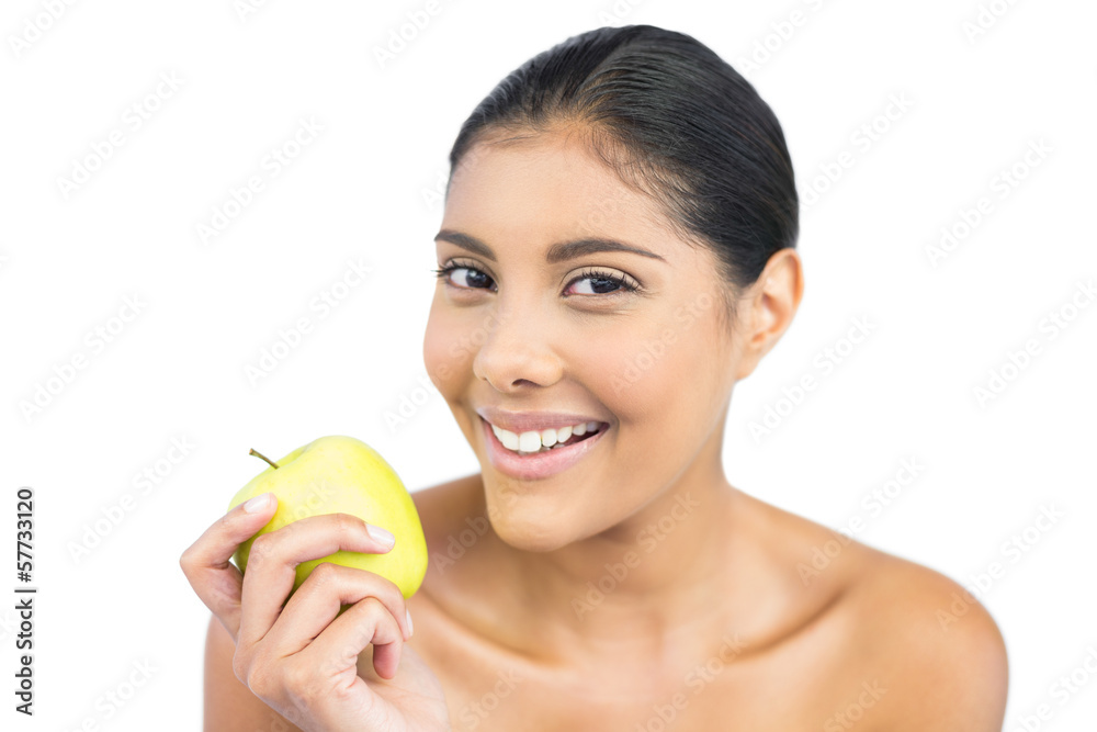 Smiling nude brunette holding green apple Smiling nude brunette holding green apple