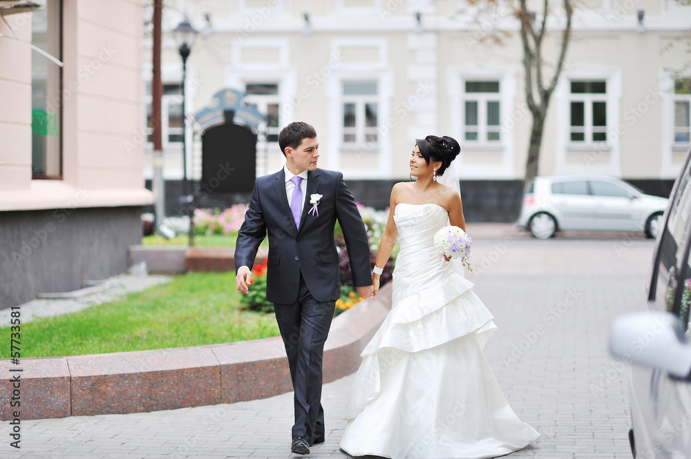 Bride and groom walking in an old town