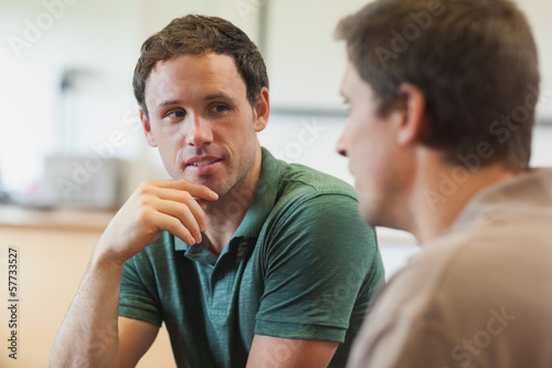 Two handsome mature students having a conversation photo