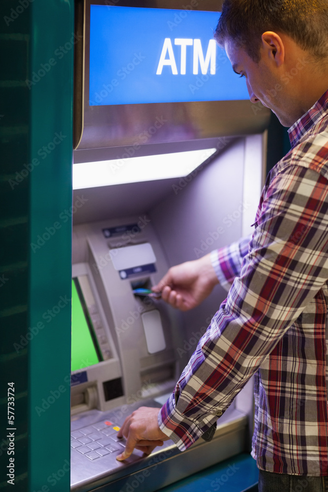 Brunette student withdrawing cash Brunette student withdrawing cash
