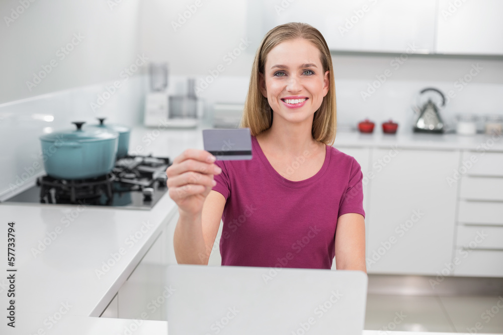 Gleeful casual woman using laptop and credit card Gleeful casual woman using laptop and credit card