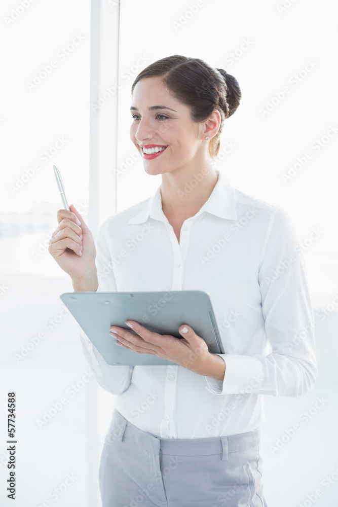 Smiling young business woman with clipboard and pen Smiling young business woman with clipboard and pen