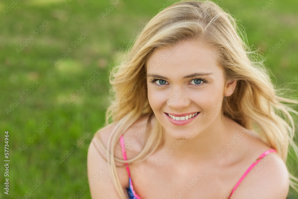 High angle view of beautiful young woman smiling at camera High angle view of beautiful young woman smiling at camera