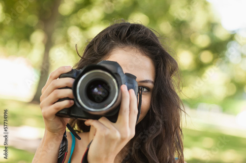 Pretty brunette woman taking a picture