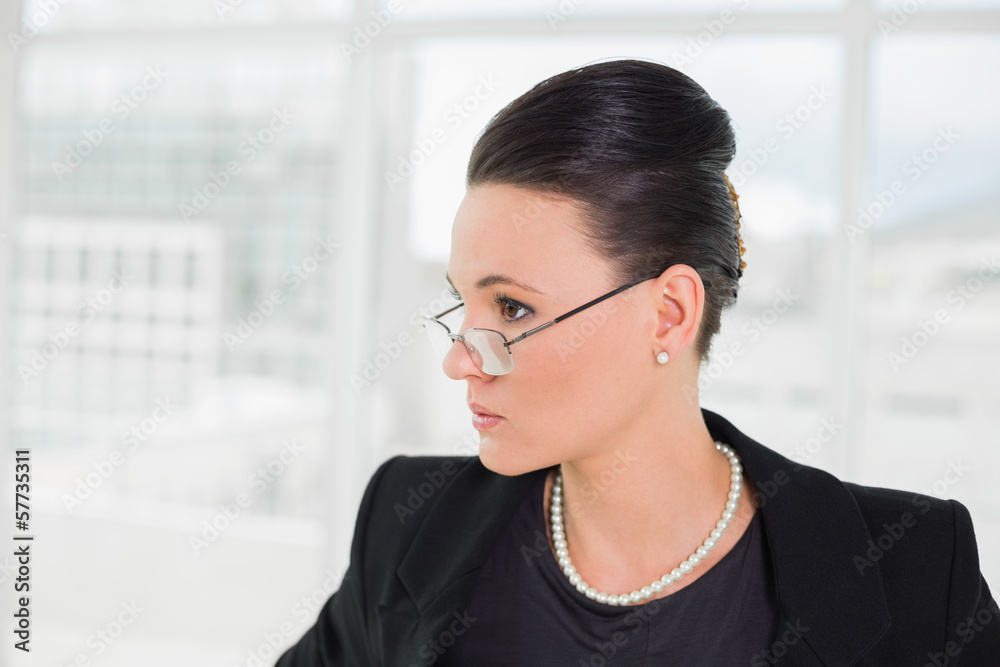 Elegant businesswoman in eyeglasses looking away Elegant businesswoman in eyeglasses looking away