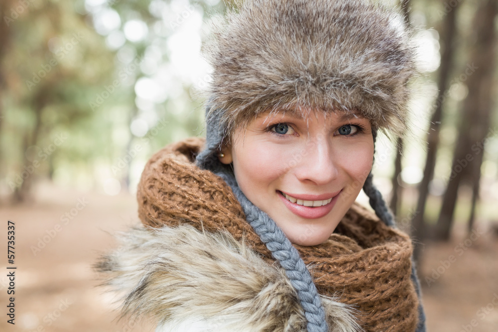 Woman in fur hat with woolen scarf in the woods Woman in fur hat with woolen scarf in the woods