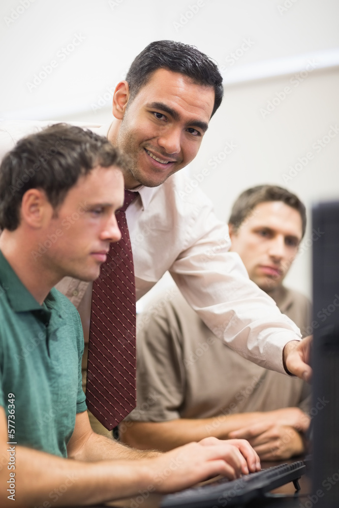 Teacher and mature student in computer room Teacher and mature student in computer room