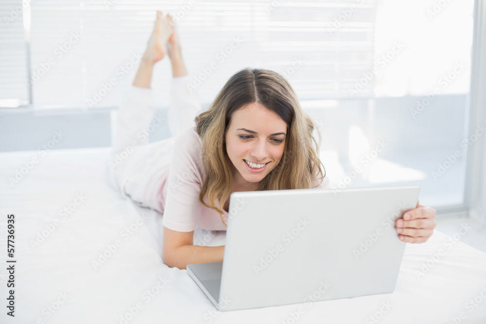 Joyful brunette woman making use of her notebook Joyful brunette woman making use of her notebook