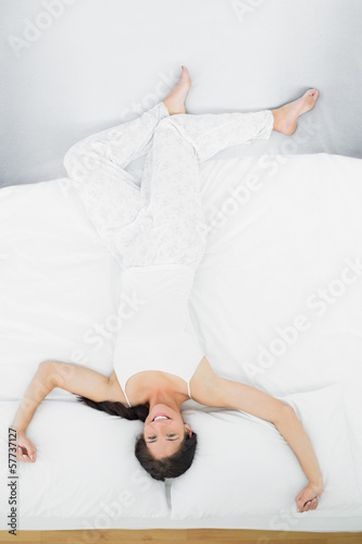 Full length of a woman lying in bed