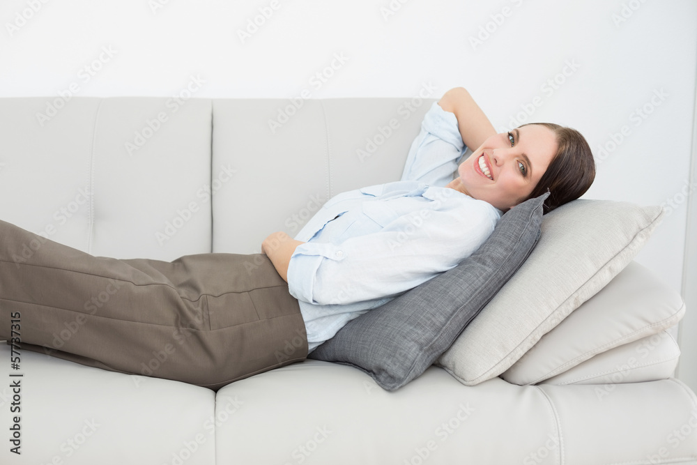 Portrait of a smiling well dressed woman relaxing on sofa Portrait of a smiling well dressed woman relaxing on sofa