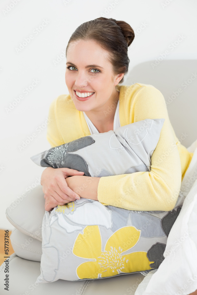 Smiling woman relaxing on sofa at home