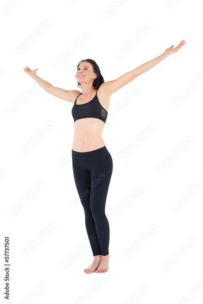 Full length of a sporty woman with hands outstretched