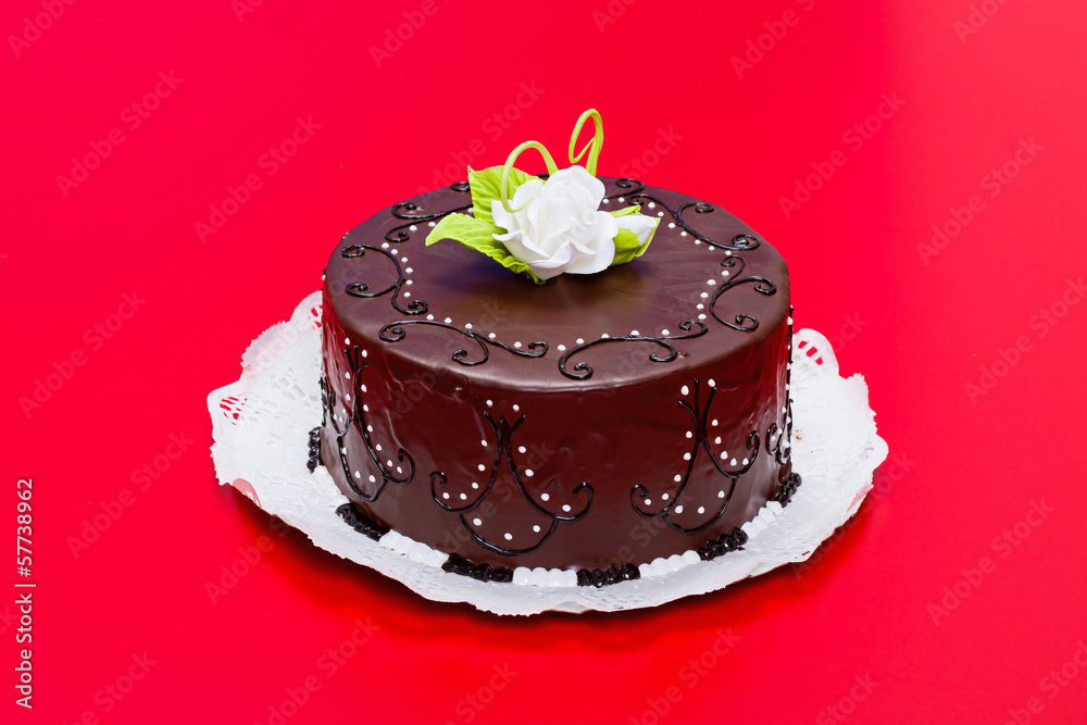 Chocolate cake with white candy rose decoration Chocolate cake with white candy rose decoration