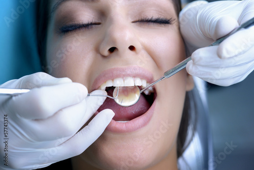 Beautiful young woman visiting dentist for dental checkup