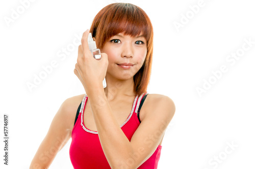 Asian female spraying hair