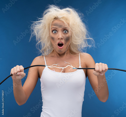 Funny girl having problem with electricity.