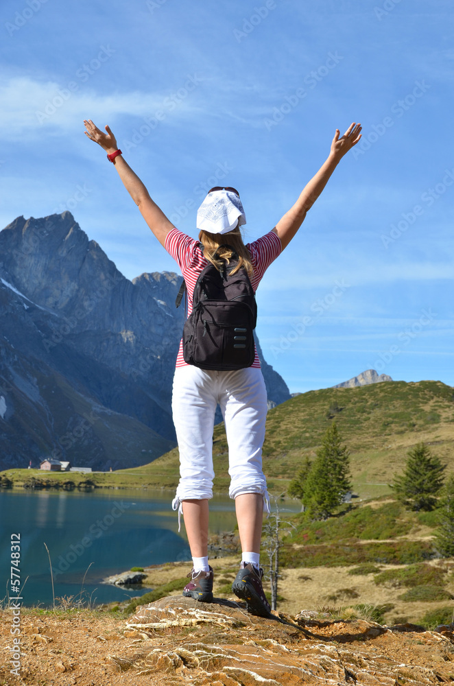 Girl enjoying Alpine panorama. Switzerland