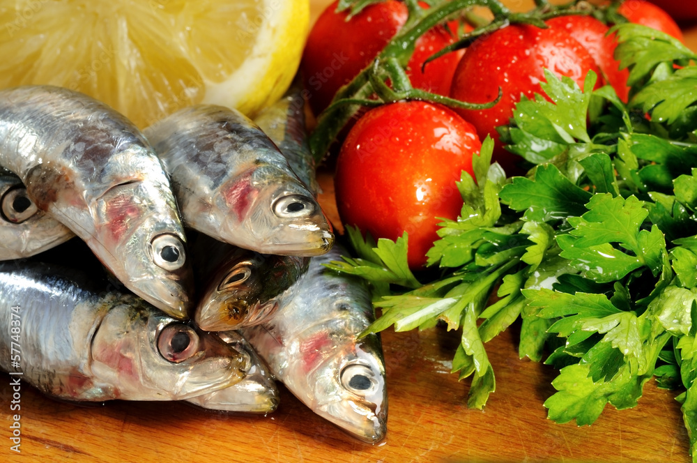 fresh sardines on Chopping Board