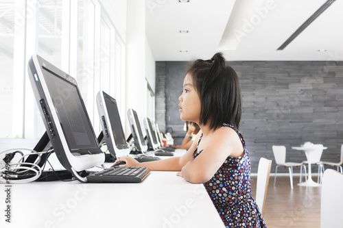 Little girl playing computer