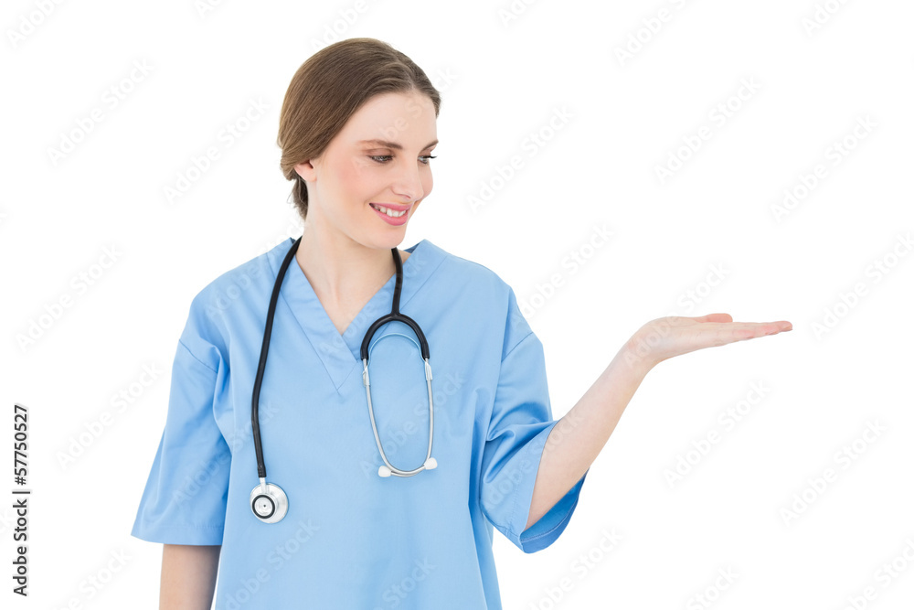 Young woman doctor presenting with her hand Young woman doctor presenting with her hand