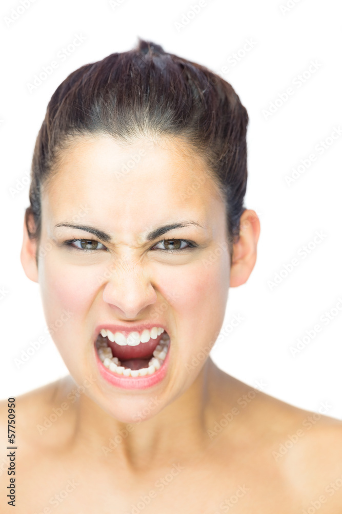 Front view of furious brunette woman yelling at camera Front view of furious brunette woman yelling at camera