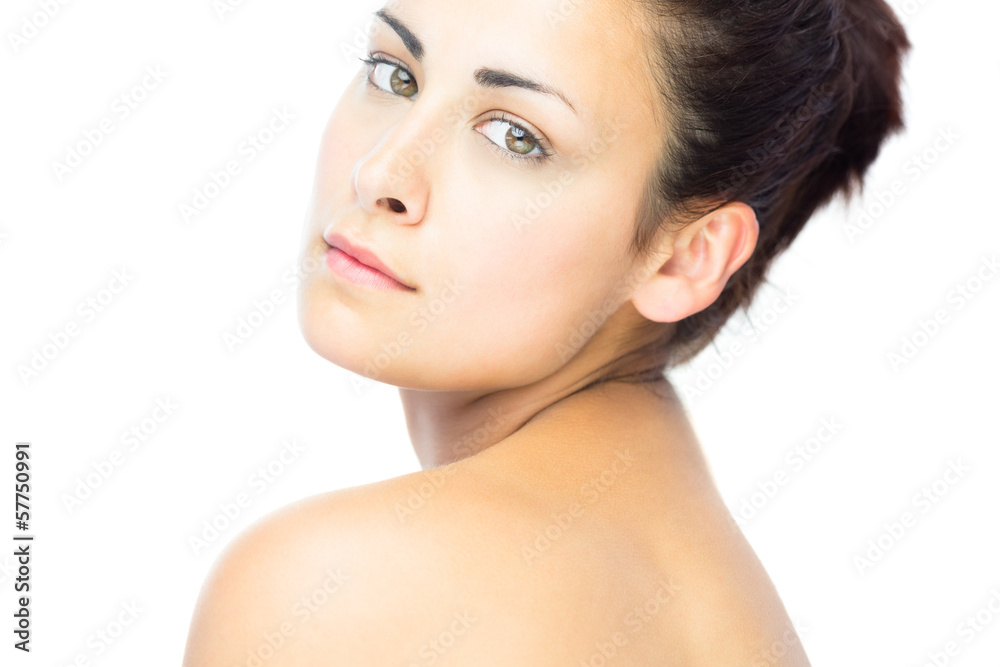 Pretty young woman looking over shoulder at camera Pretty young woman looking over shoulder at camera