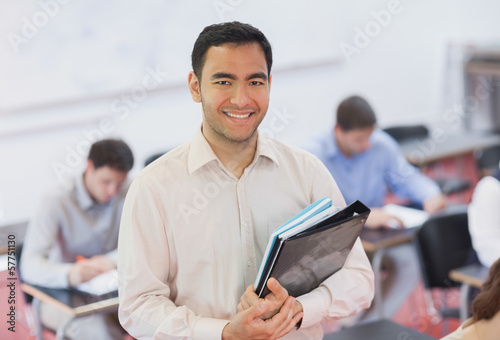 Portrait of handsome teacher posing in his classroom