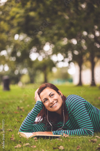 Smiling casual student lying on grass looking up © WavebreakMediaMicro