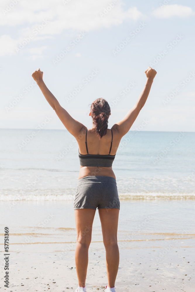 Rear view of slender brunette woman raising her arms Rear view of slender brunette woman raising her arms
