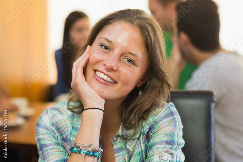 Close-up portrait of a smiling female at coffee shop