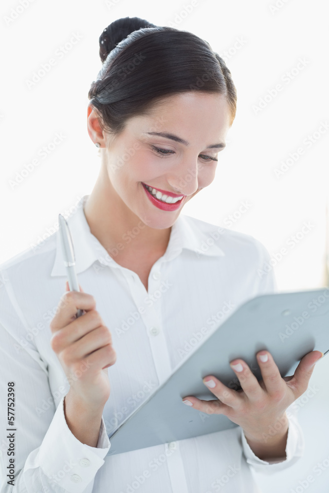 Smiling business woman with clipboard and pen Smiling business woman with clipboard and pen