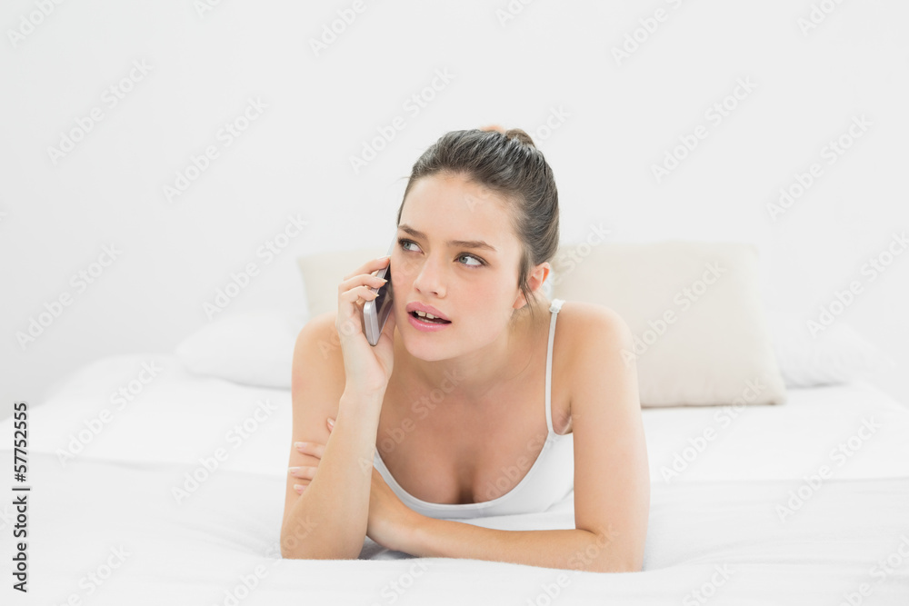 Casual woman using mobile phone in bed Casual woman using mobile phone in bed