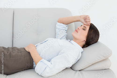 Well dressed young woman resting on sofa