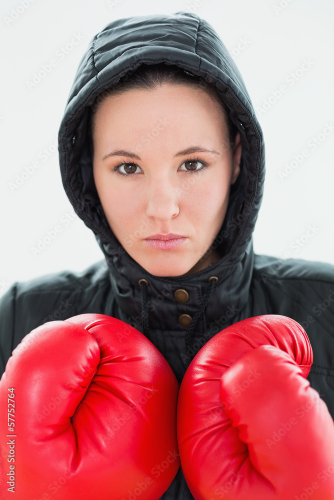 Beautiful woman in hood and red boxing gloves Beautiful woman in hood and red boxing gloves