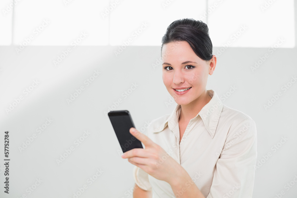Businesswoman with mobile phone in office Businesswoman with mobile phone in office
