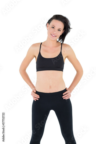 Portrait of a sporty young woman with hands on hips