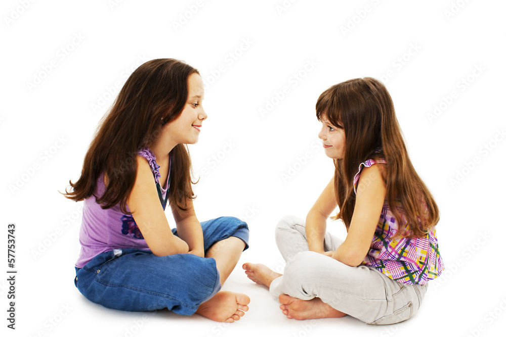 Two little girls talking on white background Two little girls talking on white background