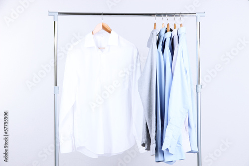 Office male clothes on hangers, on gray background © Africa Studio