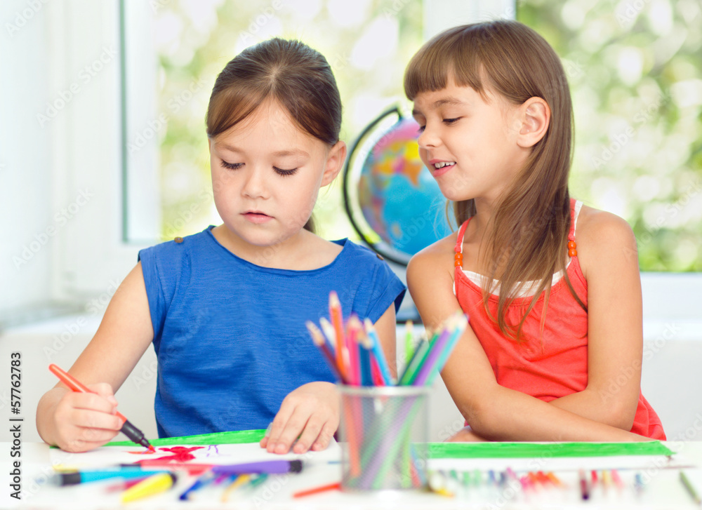 Little girls are drawing using pencils Little girls are drawing using pencils