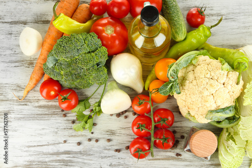 Fresh vegetables in basket on wooden table close-up